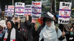 In this March 20, 2023 photo, hundreds of protesters in Jakarta, Indonesia walk in the streets against Israel's participation in the U-20 World Cup that is due to be held in the country in May.